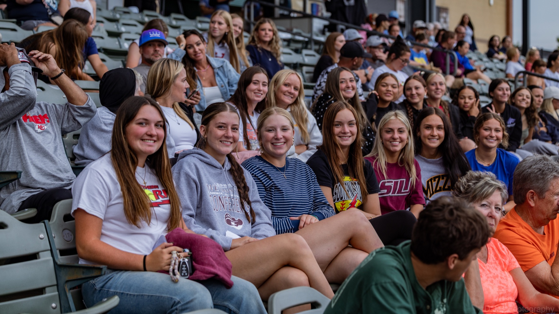 Fans smiling together in the stadium stands